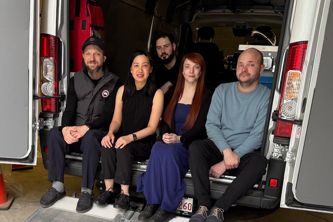 The response team seated together in the open back of the response vehicle